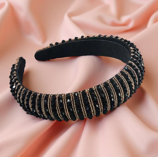 Jewel Crown Headband in Black against a Peach Background